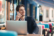 © diignat - Young entrepreneur working on laptop and phone