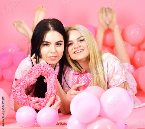Women In Pink Pajamas Posing On Camera With Pink Hearts