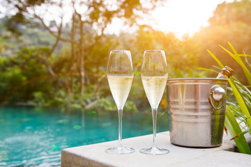 glasses of champagne near pool