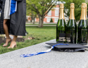 Four bottles of wine and a cap ready for celebration