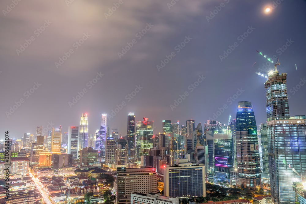 Aerial view of business, residential and under construction buildings skyscrapers at Singapore city center. Modern cityscape at blue hour - obrazy, fototapety, plakaty 
