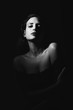 © javiindy - Young brunette woman in black lingerie in chiaroscuro lighting