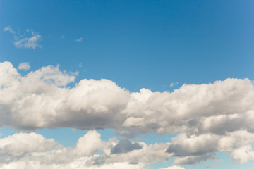 fluffy white clouds in a blue sky in sunny summer day natural backdrop