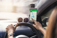 Woman Using Gps Navigation Map On Smartphone In Car