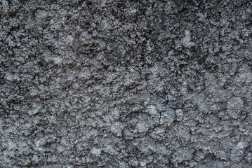 Black cracked cement texture background.