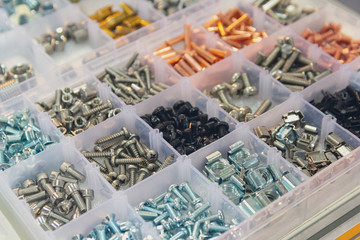 Bolts, screws, nuts, rivets on a counter of shop. Retail