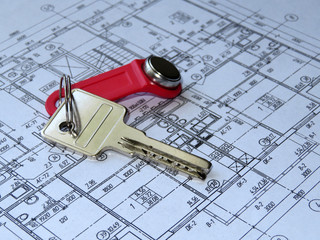 House key on the background of the home architectural plan. Apartment layout, purchase of real estate	