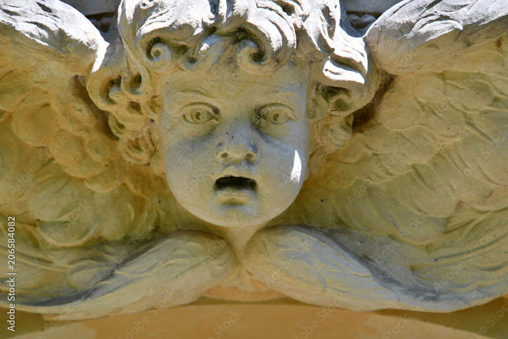 Weathered sculpture of an angel on top of a crypt. The old Berlin ...