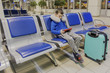© Michael - boy in an empty airport one waits for the plane and plays in his favorite gadget