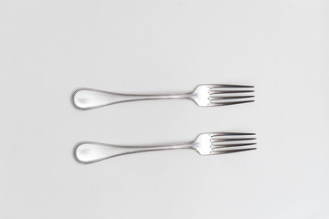 Two forks on a white background