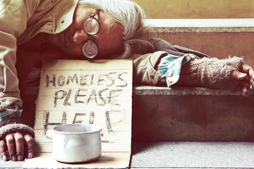 Wall Mural - Could you please help homeless man sleeping on walkway street in the capticap city.