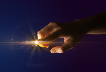 Female finger touching a beam of light