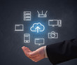 © ra2 studio - Cloud and computing related icons hovering over young hand