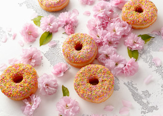 Wall Mural - Sweet pink fresh Donut decorated with japanese Flowering Cherry Tree flower