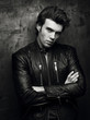 © Bakulov - Black and white portrait of a man in a black leather jacket near wall