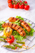 grilled tasty krakauer sausage with boiled corn and green salad