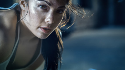 close-up shot of a beautiful athletic woman looks into camera. she's tired after intensive cross fit