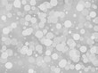© annagolant - Gray-white gradient background with bokeh effect. Abstract blurred pattern. Overlapping transparent bubbles Vector illustration