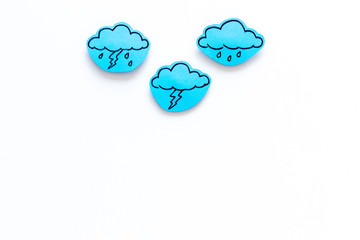 Wall Mural - rainfall forecast concept. weather icons. rainy cloud, lightening on white background top view copy 