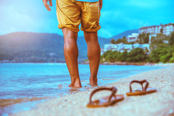 Asian man travel nature. Travel relax. Walking on the beach. In the summer