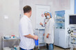 © romankosolapov - Surgeon gathered with his team of doctors before surgery