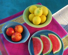 Summer Poolside Party Table With Lemons, Nectarines And Watermelon Slices In Midcentury Modern Dishware On Bright Print Tablecloth