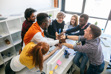 happy students of different nationalities holding hands together. friendship concept. top view image