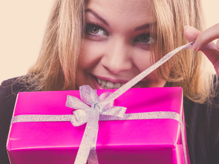 Curious woman holding gift box