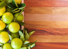 Key Lime Or Mexican Lime In A Wooden Box On Floor, One Of Main Ingredient Thai Food And Traditional Pie. Horizontal