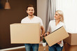 © puhhha - Moving House. Man And Woman Holding Boxes