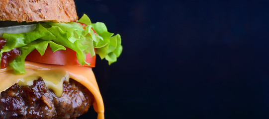 Burger flyer. Cheese burger with grilled meat, cheese, tomato, salad and onion rings. Close-up of delicious fresh home made burger with salad and cheese on bark blue background