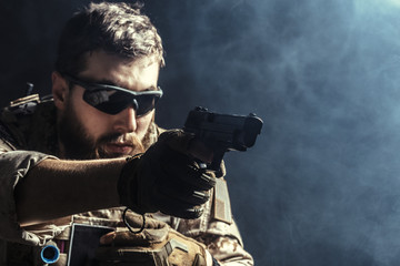 Wall Mural - Special forces soldier with rifle on dark background