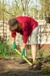 © Pereginskaya - Single Caucasian woman digging soil with shovel in the spring garden, typical Russian scene