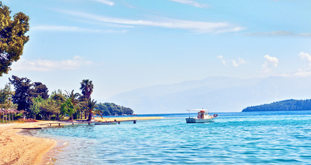 Wall Mural - beautiful scenic landscape with a boat in the bay near the beach in nydri, lefkada, greece. stunning