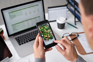 Man at work using a food ordering delivery app