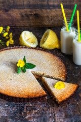 Lemon and almon tart on rustic wooden board