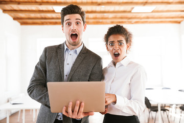 Poster - Shocked multhiethnic business couple