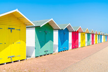 A Row Of Colorful Wooden Beach Huts On The Beach In Eastbourne, East Sussex, UK