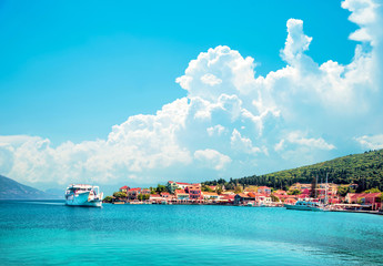 Wall Mural - beautiful scenic landscape with bay and ferry on the background of magical clouds in nydri, lefkada,