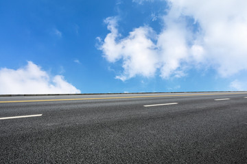 new asphalt road and sky clouds