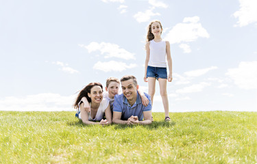 Wall Mural - Family of four outdoors in a field having fun