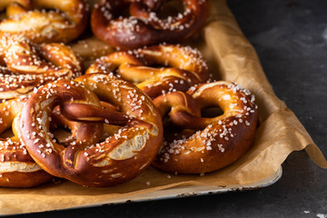 Freshly baked homemade soft pretzel with salt on rustic table. Perfect for Octoberfest. 