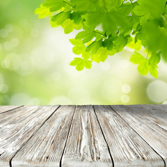 Wall Mural - white and gray shabby chic styled wooden table top with copy space for products and blurred green ba