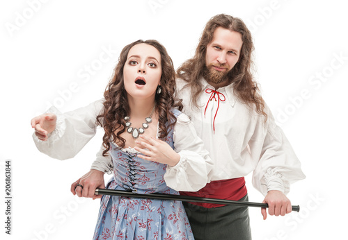Fotografie, Obraz Handsome man holding beautiful woman in medieval clothes