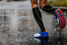 Foot Men Runner In Compression Socks Running On Rain Asphalt On Water