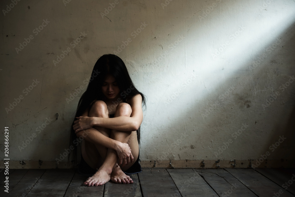 Stressed Asian woman in  dark room - obrazy, fototapety, plakaty 