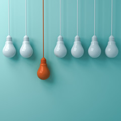 Leinwandbilder - Think different concept , One hanging orange light bulb standing out from the white light bulbs on green pastel wall background , leadership and individuality creative idea concepts . 3D rendering.