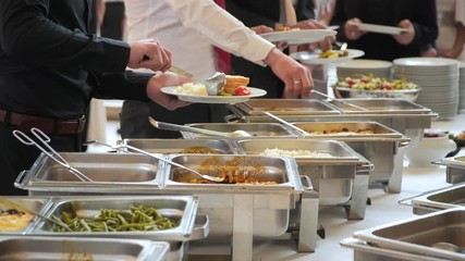 Wall Mural - Buffet guests put food in the plates.