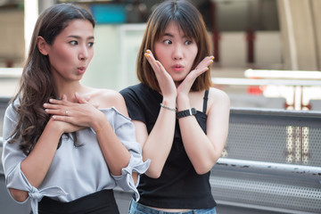 Wall Mural - excited women looking with surprise and interest; portrait of surprised girls, excited asian women with exciting, oh, uh, ah, wow interesting face expression; asian young adult women model