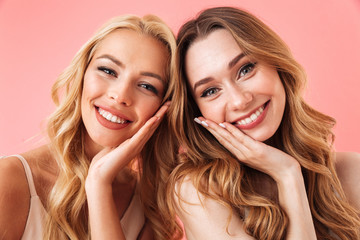 Close up image of Two happy pretty women in dresses